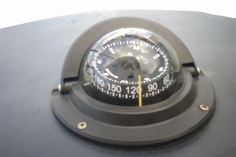 Slide: The Image of Compass on 2013 Chaparral 327 SSX boat dashboard, showing navigation directions. - 25