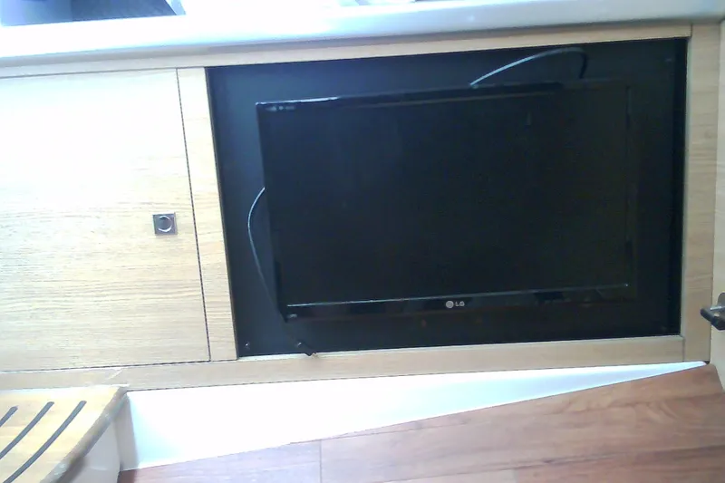 Slide: The Image of Built-in LG TV on 2013 Chaparral 327 SSX boat interior. - 32