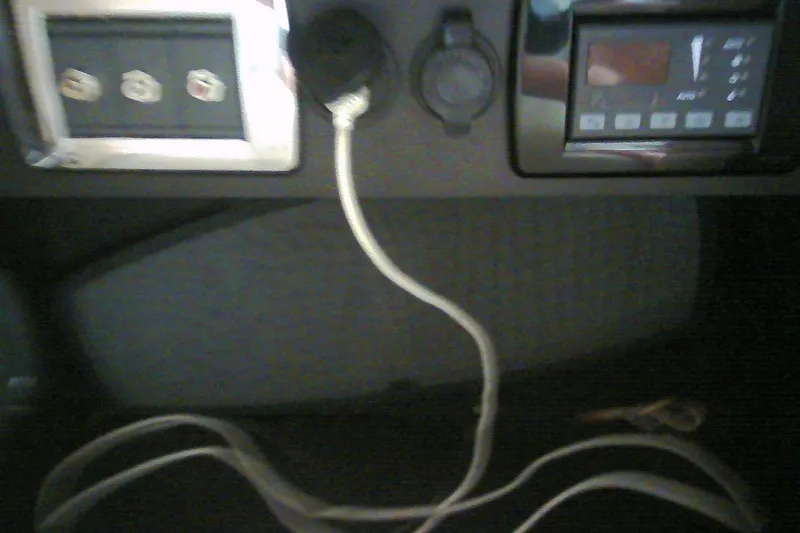Slide: The Image of Control panel of a 2013 Chaparral 327 SSX boat with connected cables. - 34