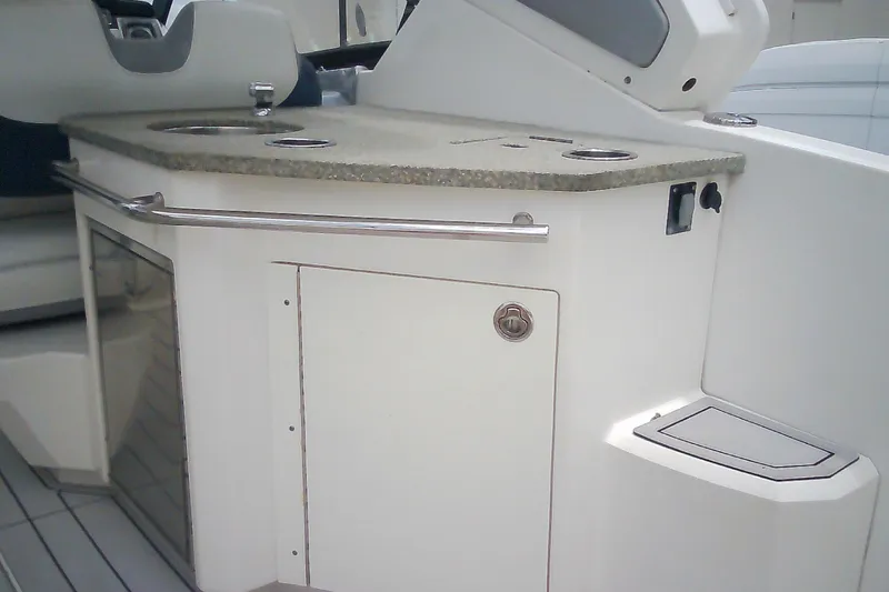 Slide: The Image of 2013 Chaparral 327 SSX boat interior with kitchenette and storage area. - 36