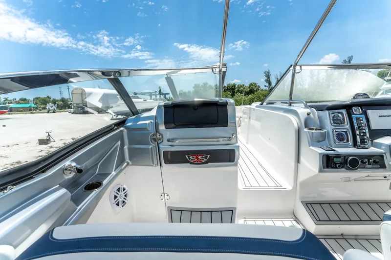 Slide: The Image of Interior view of 2013 Chaparral 327 SSX boat cockpit under clear blue sky. - 55
