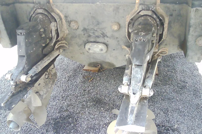 Slide: The Image of Close-up of 2013 Chaparral 327 SSX boat's dual propeller system on gravel surface. - 38