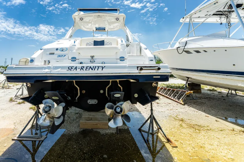 Slide: The Image of 2013 Chaparral 327 SSX boat named "Sea-Renity" on dry dock under clear blue sky. - 75