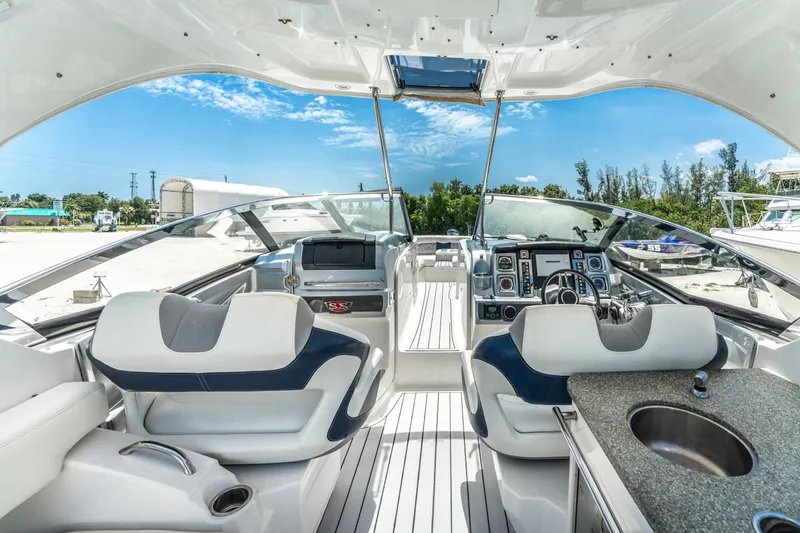 Slide: The Image of 2013 Chaparral 327 SSX boat interior with modern dashboard and seating. - 47