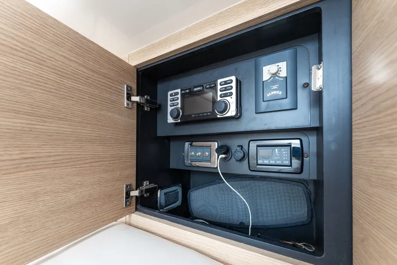 Slide: The Image of 2013 Chaparral 327 SSX boat interior electronics panel with radio and control systems. - 36