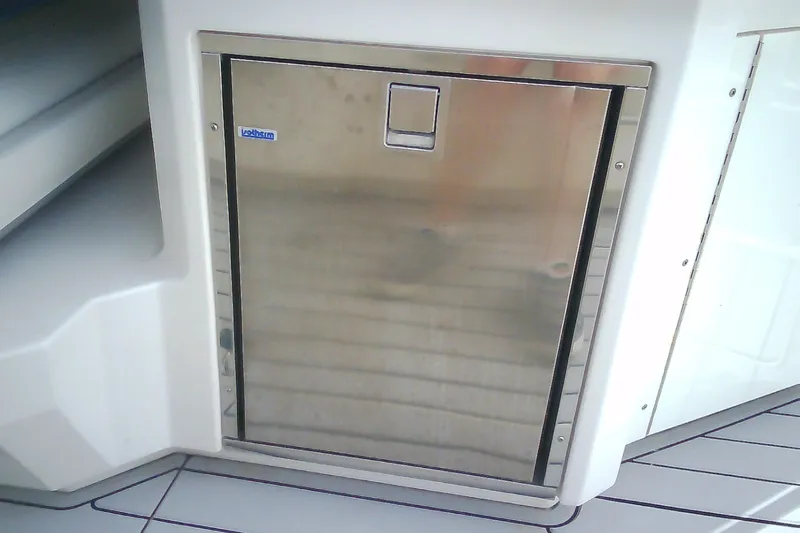 Slide: The Image of Stainless steel refrigerator on 2013 Chaparral 327 SSX boat interior. - 9