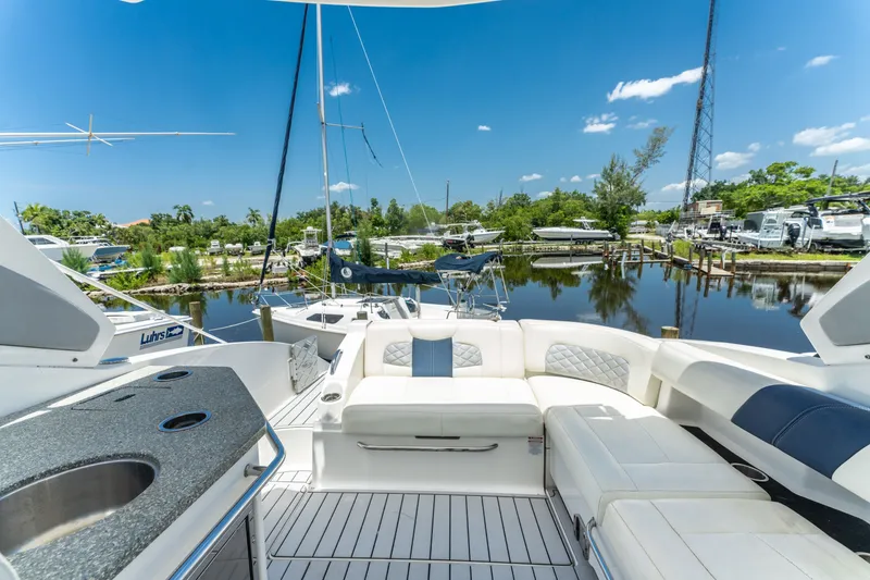 Slide: The Image of 2013 Chaparral 327 SSX boat interior with luxurious seating and marina view. - 65