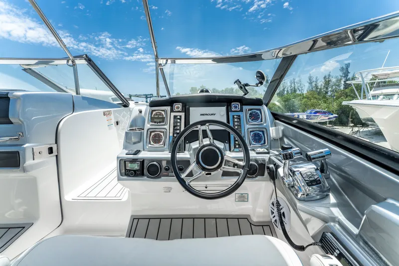 Slide: The Image of Cockpit of 2013 Chaparral 327 SSX boat with modern controls and steering wheel. - 53