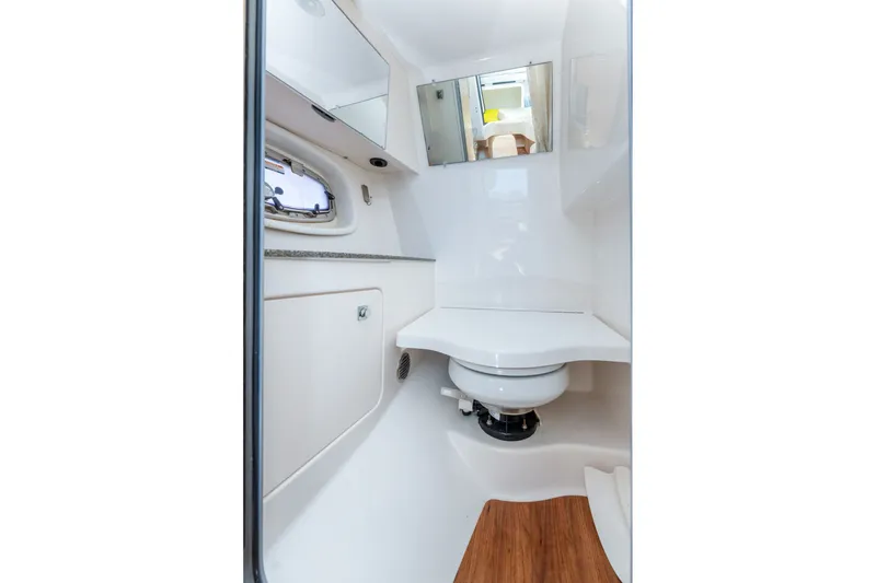 Slide: The Image of 2013 Chaparral 327 SSX boat bathroom with modern fixtures and wood flooring. - 46