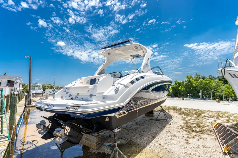 Slide: The Image of 2013 Chaparral 327 SSX boat on dry dock under a bright blue sky. - 84