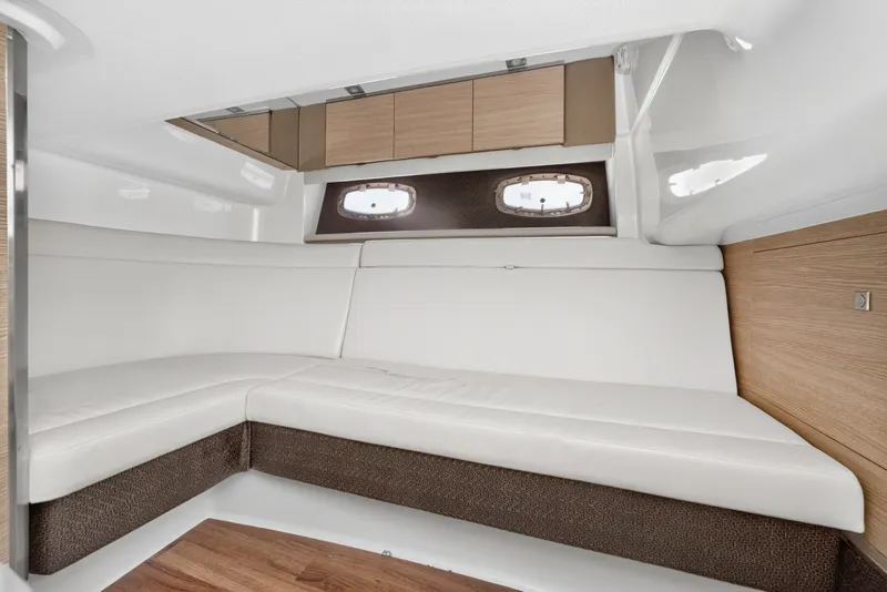 Slide: The Image of Interior cabin of 2013 Chaparral 327 SSX with white seating and wood accents. - 38