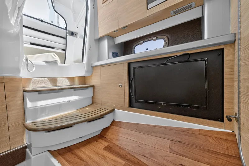 Slide: The Image of Interior of 2013 Chaparral 327 SSX boat with wooden flooring and built-in TV. - 42