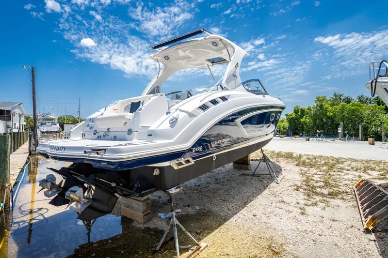 Slide: The Image of 2013 Chaparral 327 SSX boat on dry dock under clear blue sky. - 34