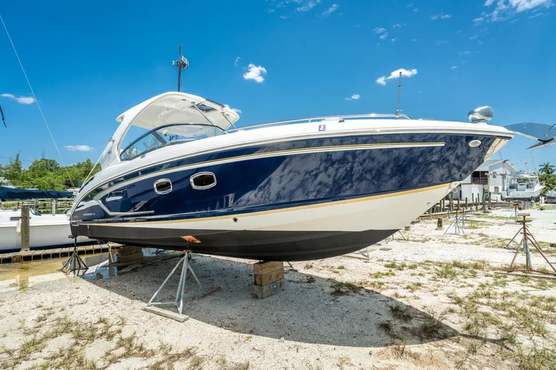 Slide: The Image of 2013 Chaparral 327 SSX boat on dry dock under clear blue sky. - 80