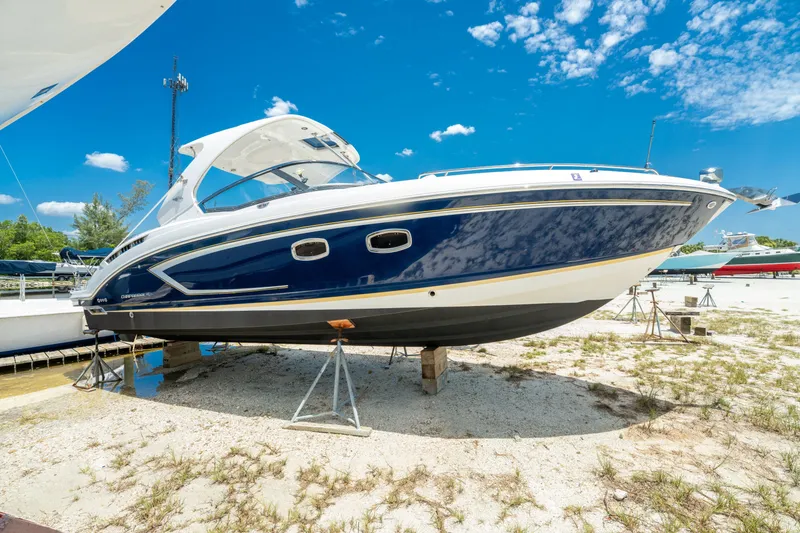 Slide: The Image of 2013 Chaparral 327 SSX boat on stands under a clear blue sky. - 81