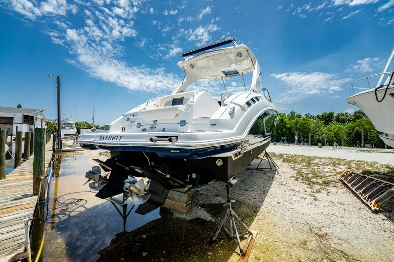Slide: The Image of 2013 Chaparral 327 SSX boat on dry dock under a clear blue sky. - 74