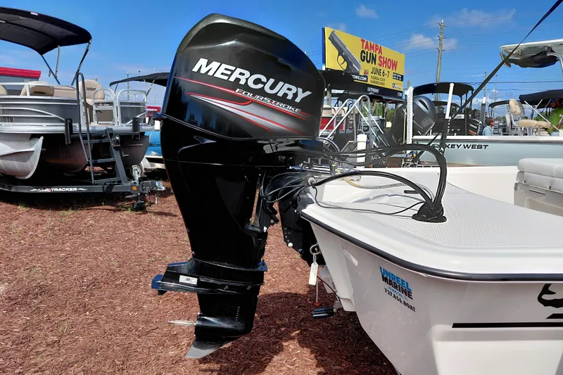 Slide: The Image of 2015 Mako Pro Skiff 17 CC with Mercury outboard motor at a boat show. - 10