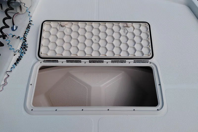 Slide: The Image of Open storage hatch on 2015 Mako Pro Skiff 17 CC boat deck. - 21