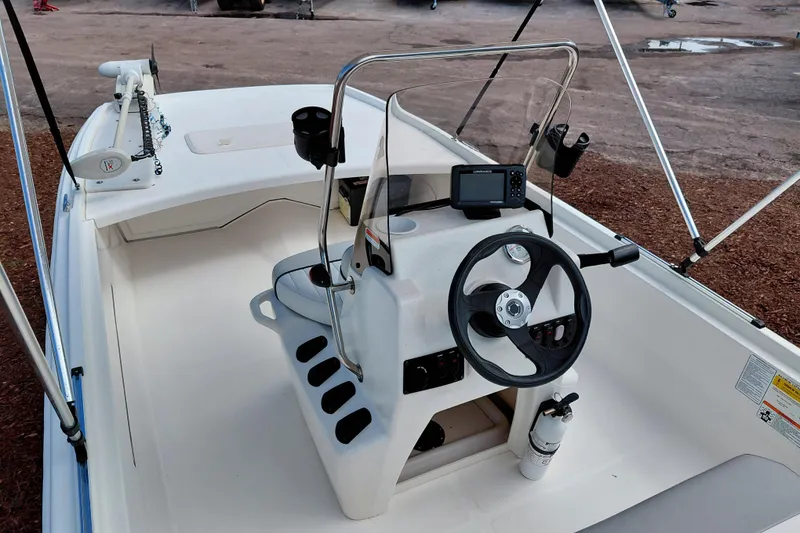 Slide: The Image of 2015 Mako Pro Skiff 17 CC boat interior with steering console and navigation equipment. - 29