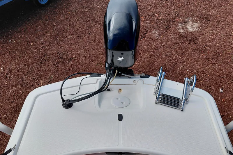 Slide: The Image of 2015 Mako Pro Skiff 17 CC boat with motor and ladder on deck. - 30