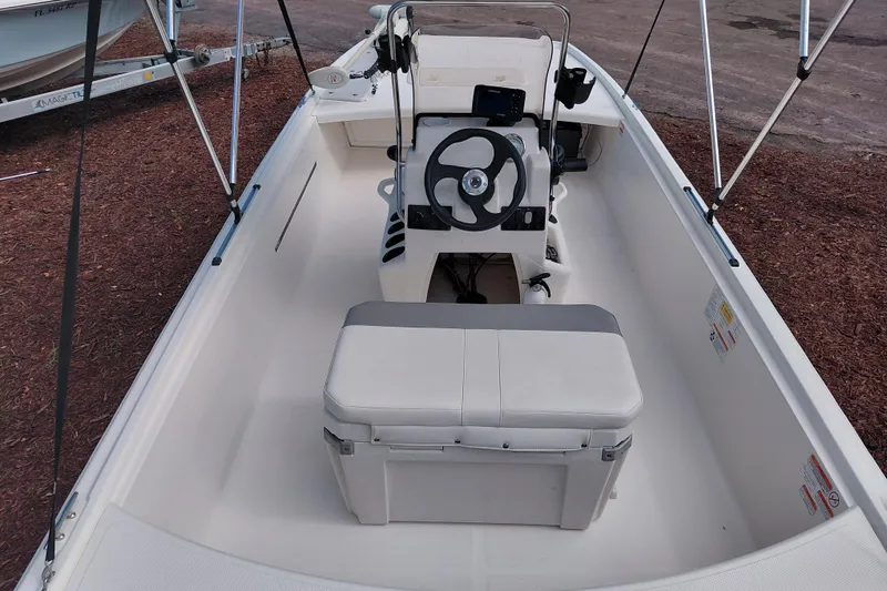 Slide: The Image of 2015 Mako Pro Skiff 17 CC boat interior with steering console and seating. - 36