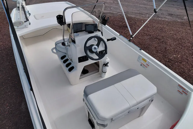 Slide: The Image of 2015 Mako Pro Skiff 17 CC boat interior with steering console and seating. - 38