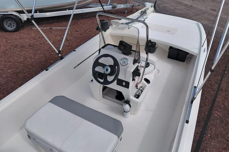 Slide: The Image of 2015 Mako Pro Skiff 17 CC boat interior with steering console and seating. - 39