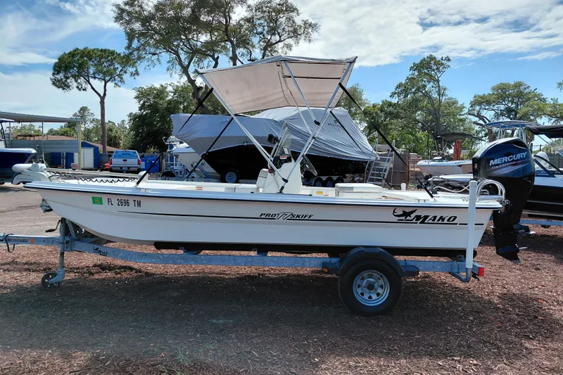 Slide: The Image of 2015 Mako Pro Skiff 17 CC boat on trailer, parked outdoors. - 4