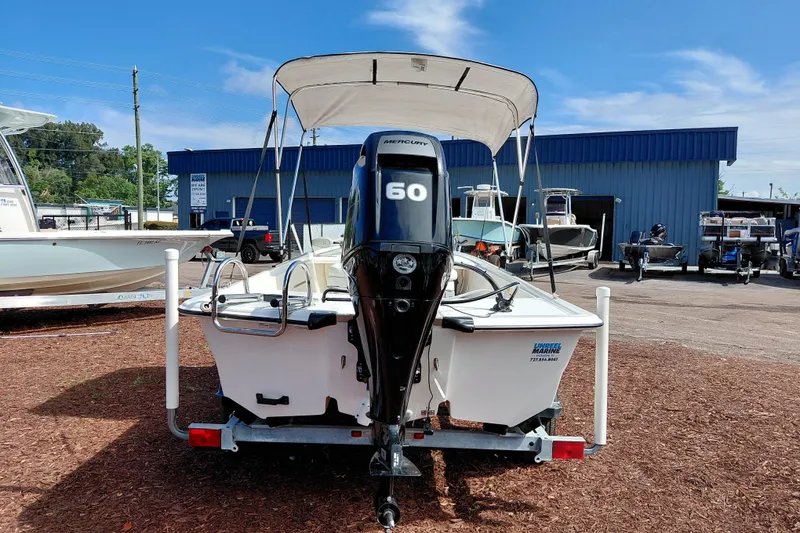 Slide: The Image of 2015 Mako Pro Skiff 17 CC with Mercury 60 engine at a boat dealership. - 6
