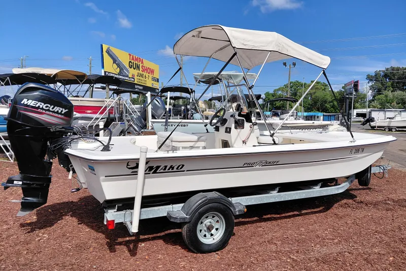 Slide: The Image of 2015 Mako Pro Skiff 17 CC boat with Mercury engine on trailer, outdoor display. - 8