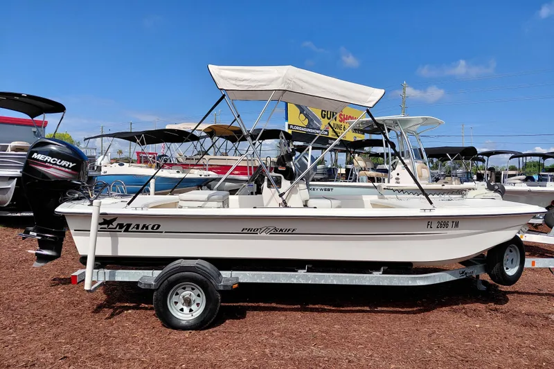 Slide: The Image of 2015 Mako Pro Skiff 17 CC boat on trailer with Mercury outboard motor. - 9