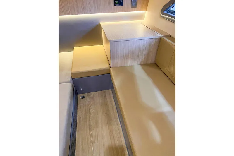 Slide: The Image of Modern interior seating in a 2027 Hanover 387, featuring sleek wood and beige upholstery. - 1