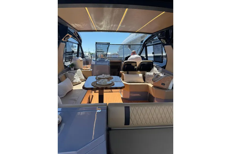 Slide: The Image of Luxurious interior of 2027 Hanover 387 yacht with elegant seating and dining area. - 3