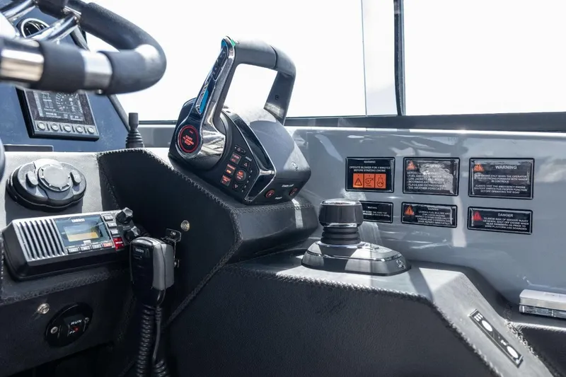 Slide: The Image of Control panel of a 2027 Hanover 387 boat with steering wheel and navigation controls. - 9