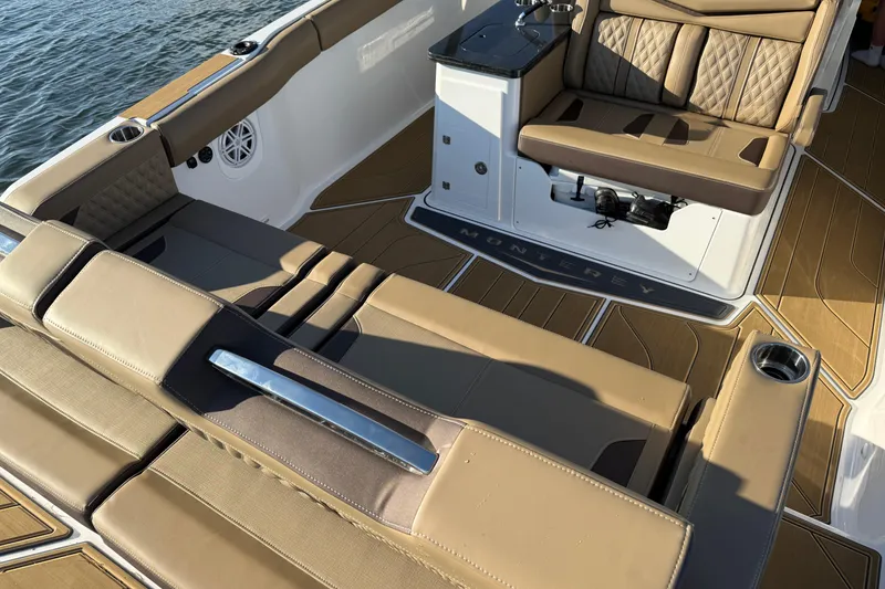 Slide: The Image of Luxurious interior of 2026 Monterey Elite 30 OB boat with tan seating and sleek design. - 17