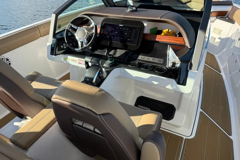 Slide: The Image of 2026 Monterey Elite 30 OB boat cockpit with modern steering and dashboard controls. - 19