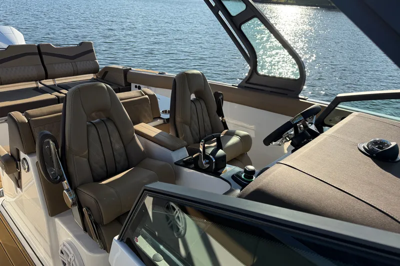Slide: The Image of Luxurious interior of 2026 Monterey Elite 30 OB boat with leather seating and modern controls. - 20