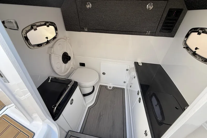 Slide: The Image of Modern bathroom interior of 2026 Monterey Elite 30 OB boat, featuring sleek design and compact amenities. - 23