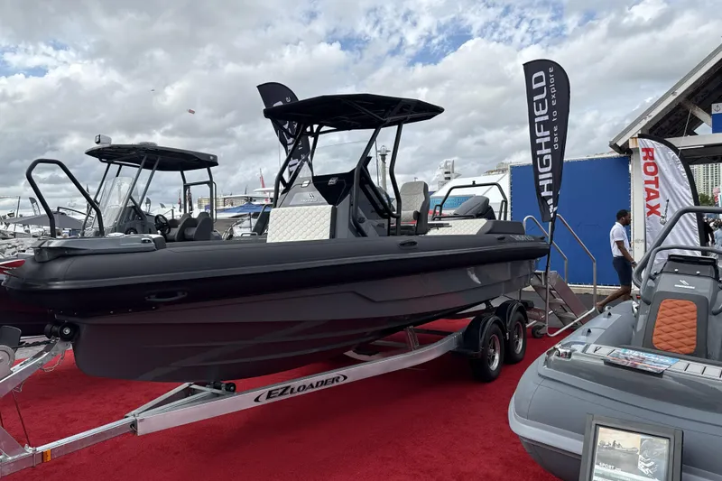 The Image of 2027 Highfield ADV7 boat on display with EZ Loader trailer at a marine exhibition. - 0