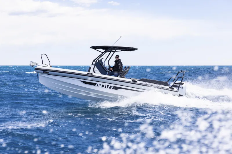 Slide: The Image of 2026 Highfield ADV7 boat cruising on open sea with a person at the helm. - 2