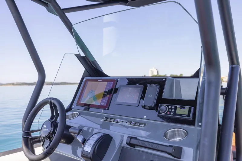 Slide: The Image of Highfield ADV7 2026 boat dashboard with navigation system and controls on a calm sea. - 5