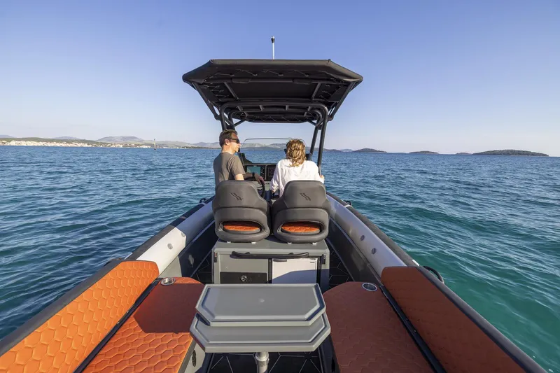 Slide: The Image of 2026 Highfield ADV7 boat cruising on open water with two passengers. - 6