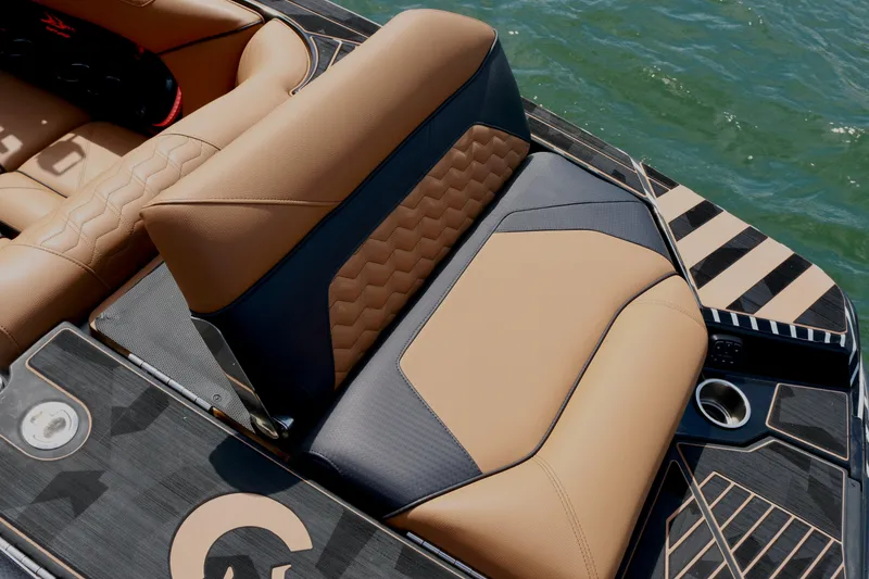 Slide: The Image of 2024 Centurion Ri265 boat interior with luxurious tan and black seating design. - 10