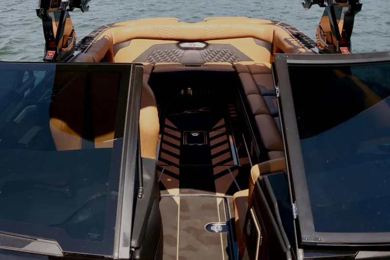 Slide: The Image of 2024 Centurion Ri265 boat interior with luxurious seating and sleek design on the water. - 17