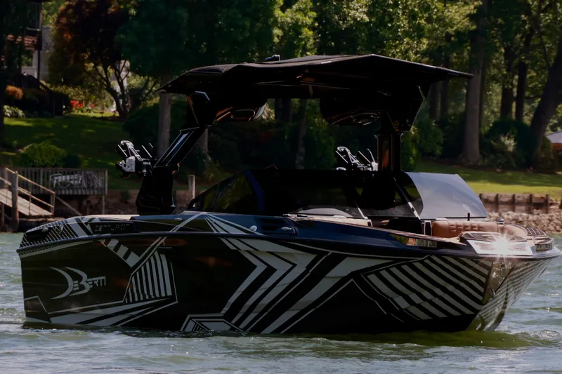 Slide: The Image of 2024 Centurion Ri265 boat with sleek design on a scenic lake. - 3