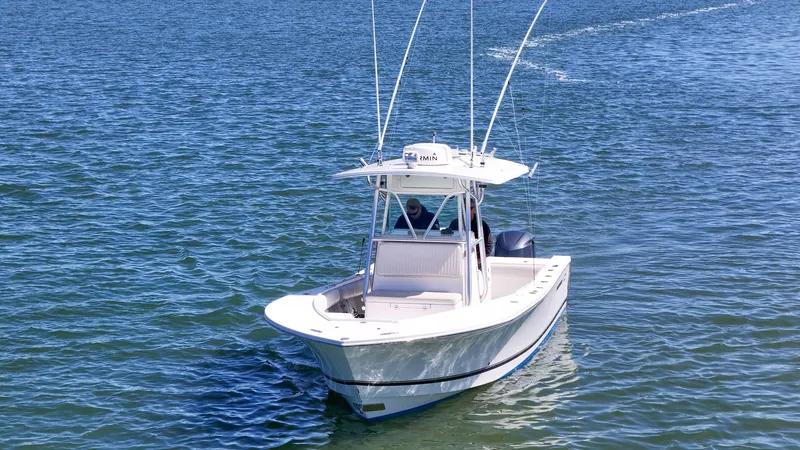Slide: The Image of 2006 Regulator 29 Forward Seating boat on calm water. - 33