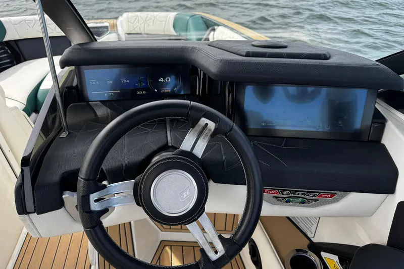 Slide: The Image of 2020 Nautique Super Air Nautique G23 Paragon dashboard with steering wheel and digital displays. - 16