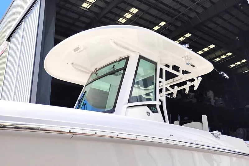 Slide: The Image of 2018 Boston Whaler 280 Outrage boat with sleek design in a marina setting. - 11