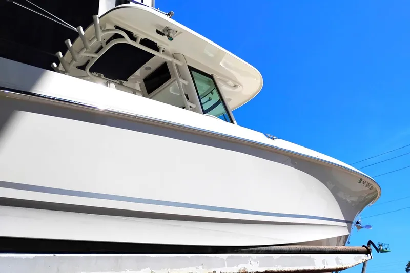 Slide: The Image of 2018 Boston Whaler 280 Outrage boat against clear blue sky. - 13