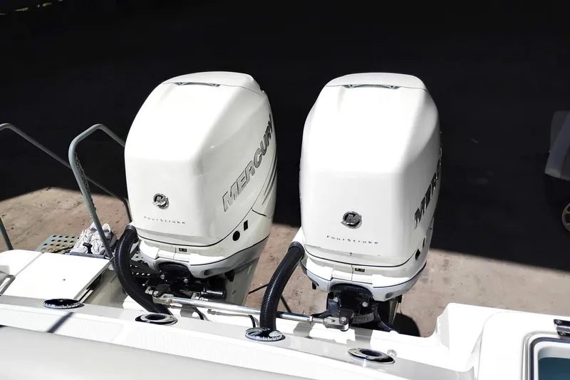Slide: The Image of Twin Mercury outboard engines on a 2018 Boston Whaler 280 Outrage boat. - 20